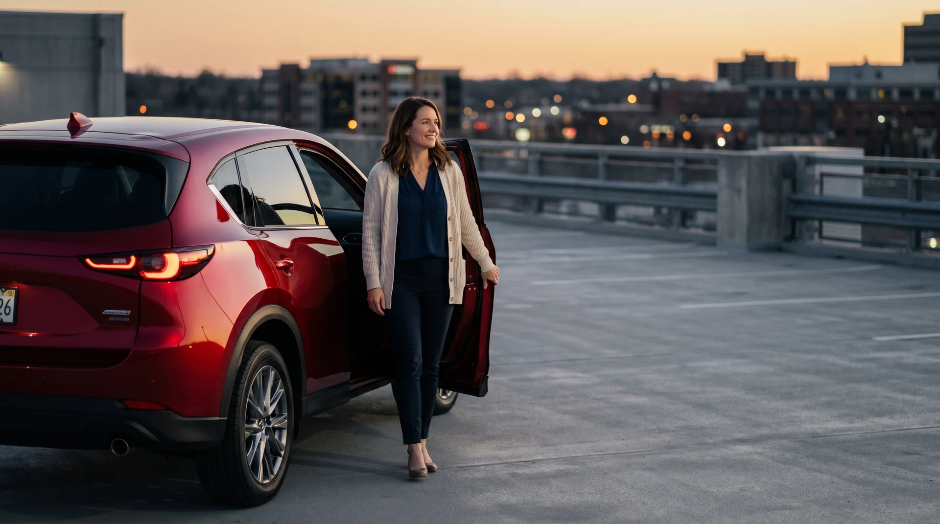 A Forsyth County educator beside a Mazda CX-5 at golden hour